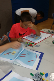 Hayden Danner, a 4th Grade student at West Fannin Elementary is working on customizing his robot
