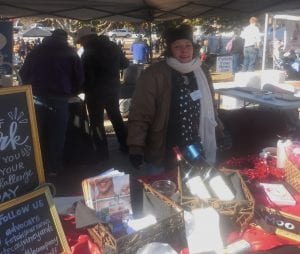 Lisa Pritchard showing off one of her chili ingredients, wine from Cartecay Vineyards