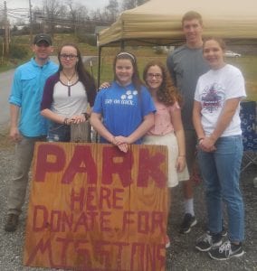 Hunter Brown, Caroline Scoggins, Caitlyn Adams, Andrew Ladd and Hannah Ladd of Temple Baptist Church collect parking donations for their summer camp.
