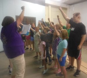 The Super-hero-ish good guys practice their victory song.