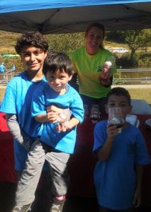 Ashya Brooks of Blue Ridge's Dairy Queen serves ice cream to the Saldana family at the cleanup.